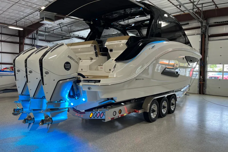 Slide: The Image of 2025 Sea Ray Sundancer 370 Outboard in a showroom, featuring triple Mercury engines. - 34