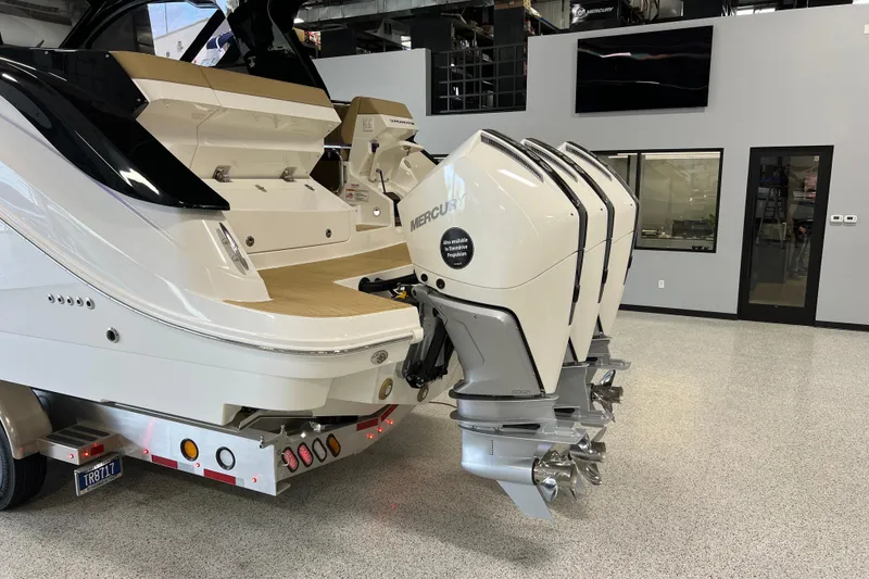 Slide: The Image of 2025 Sea Ray Sundancer 370 Outboard with triple Mercury engines in showroom. - 36