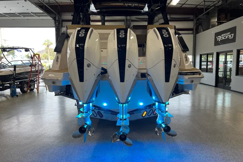 Slide: The Image of 2025 Sea Ray Sundancer 370 Outboard with triple engines in a showroom setting. - 39