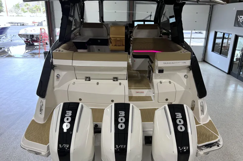 Slide: The Image of 2025 Sea Ray Sundancer 370 Outboard with triple V8 engines in a showroom setting. - 4