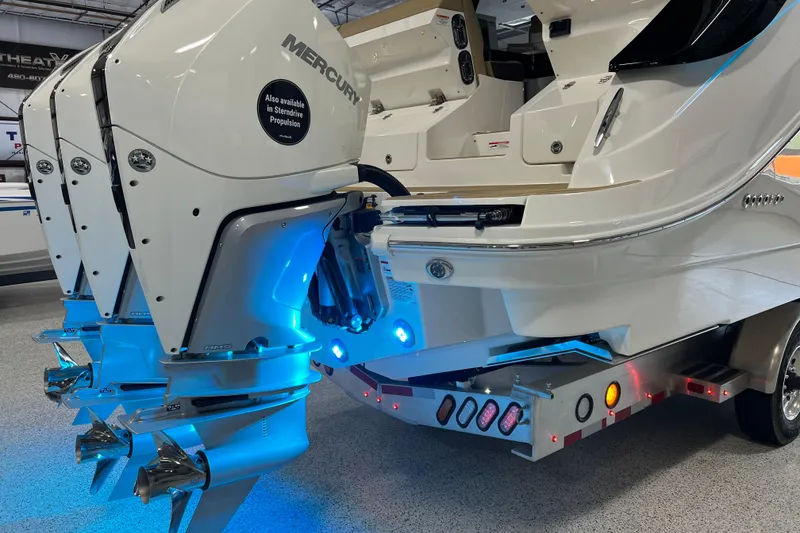 Slide: The Image of 2025 Sea Ray Sundancer 370 Outboard with Mercury engines, illuminated in a showroom setting. - 40