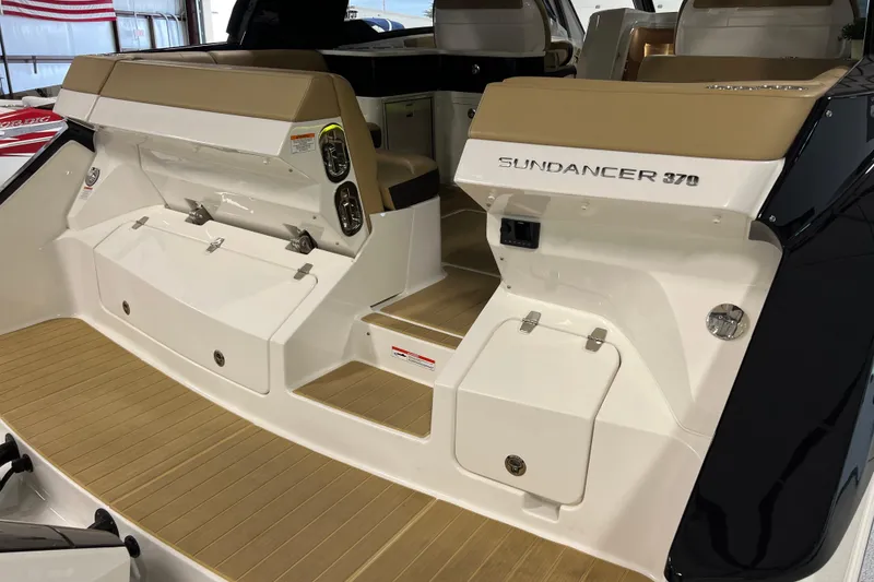 Slide: The Image of 2025 Sea Ray Sundancer 370 Outboard boat interior with tan seating and sleek design. - 9