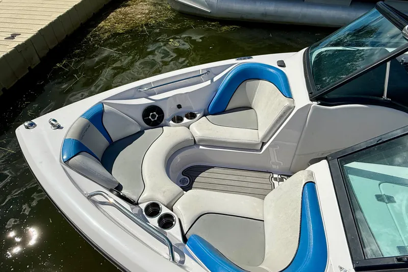 Slide: The Image of 2000 Correct Craft Super Air Nautique boat interior with blue and gray seating. - 10