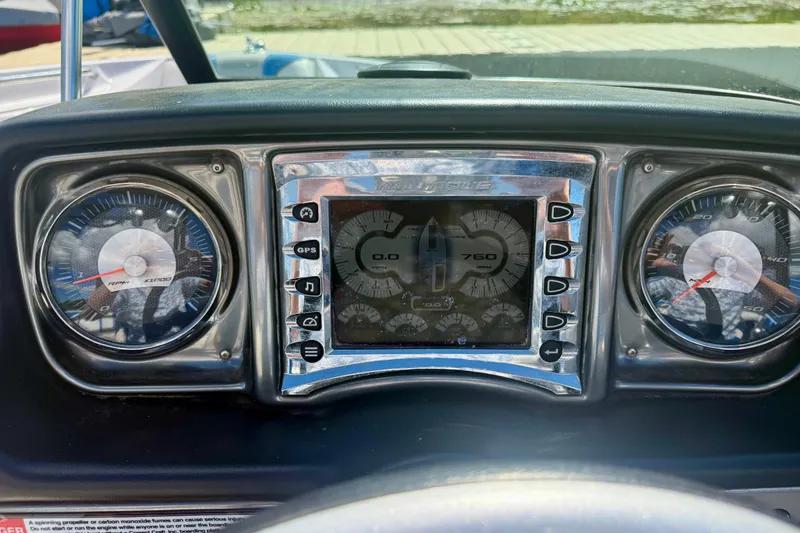 Slide: The Image of Dashboard of a 2000 Correct Craft Super Air Nautique boat with gauges and controls. - 17