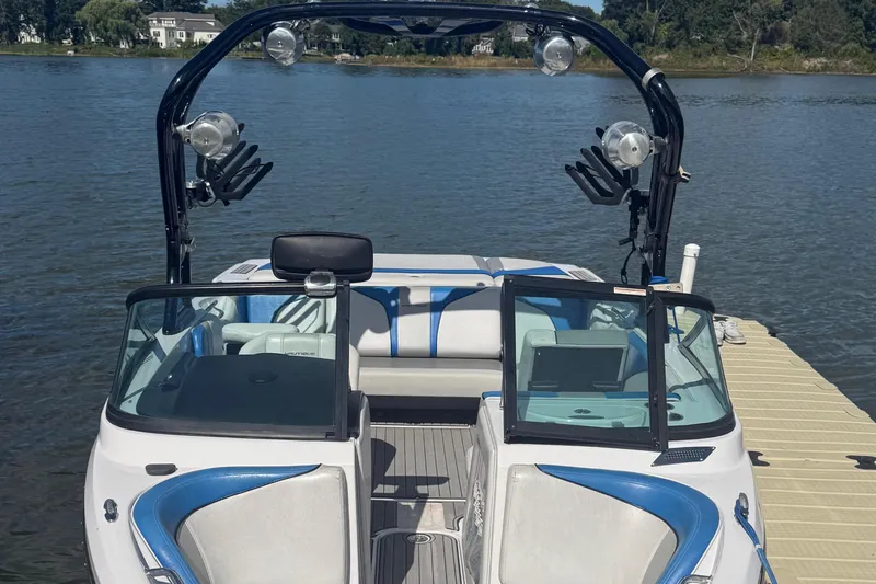 Slide: The Image of 2000 Correct Craft Super Air Nautique boat docked on a serene lake. - 3