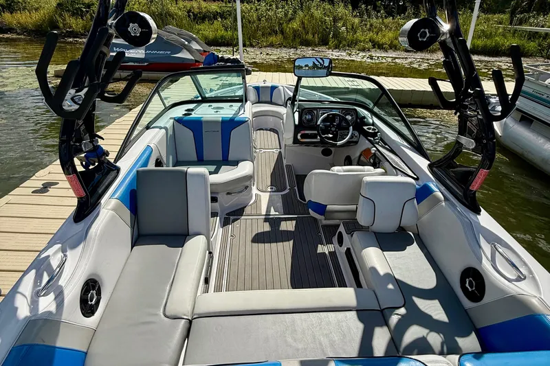 Slide: The Image of Interior of a 2000 Correct Craft Super Air Nautique boat, featuring seating and dashboard. - 6