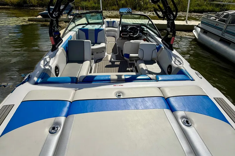 Slide: The Image of 2000 Correct Craft Super Air Nautique boat interior with blue and white seating. - 7