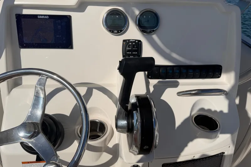 Slide: The Image of 2023 Sailfish 220 CC boat dashboard with steering wheel and controls. - 15