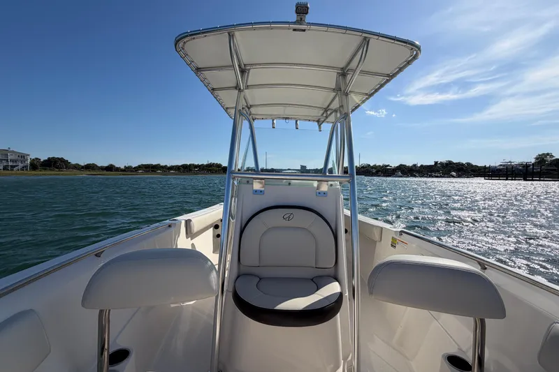 Slide: The Image of 2023 Sailfish 220 CC boat on water, featuring a sleek design and comfortable seating. - 23