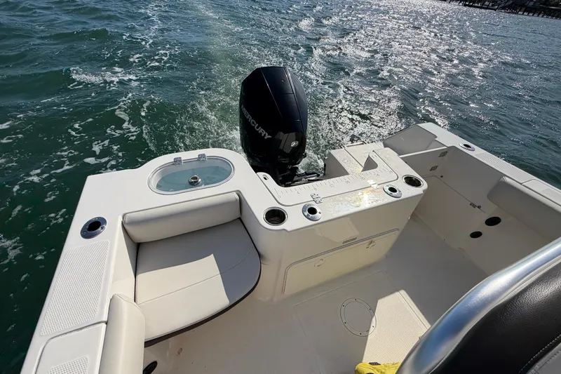 Slide: The Image of 2023 Sailfish 220 CC boat interior with Mercury engine on water. - 25