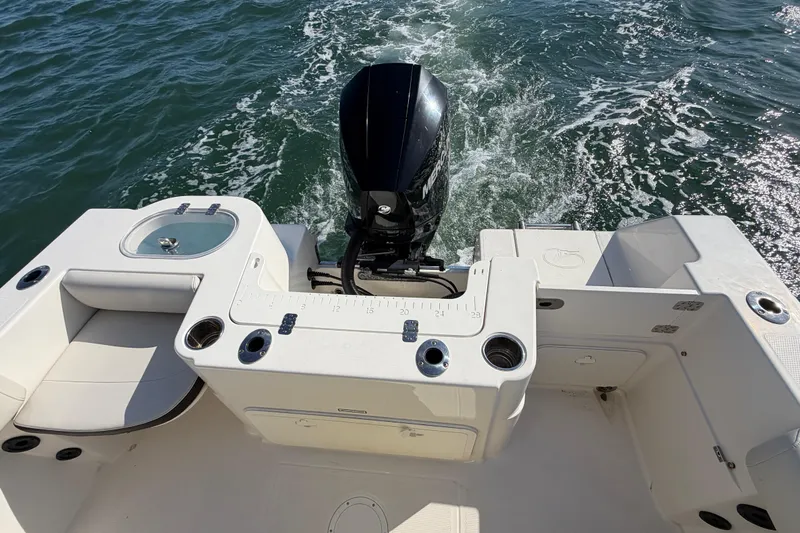 Slide: The Image of 2023 Sailfish 220 CC boat with outboard motor on water. - 26