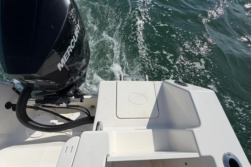 Slide: The Image of 2023 Sailfish 220 CC boat with Mercury engine on water. - 27