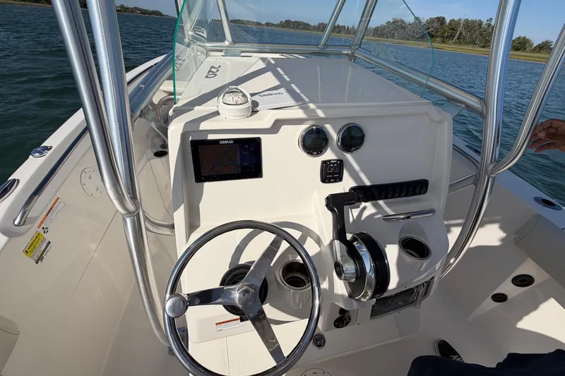 Slide: The Image of 2023 Sailfish 220 CC boat console with steering wheel and navigation system. - 28