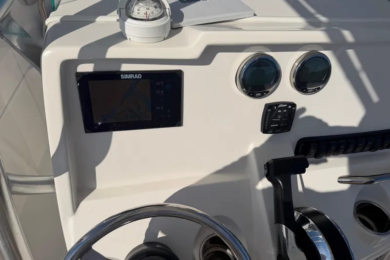 Slide: The Image of 2023 Sailfish 220 CC boat dashboard with Simrad display and compass. - 29
