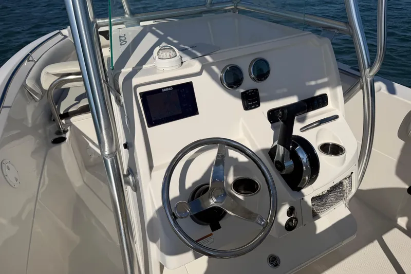 Slide: The Image of 2023 Sailfish 220 CC boat console with steering wheel and navigation controls. - 33
