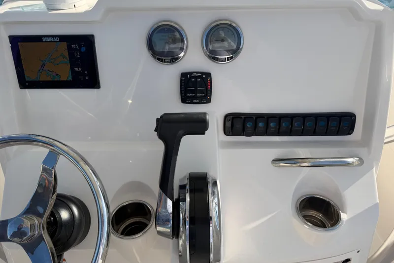 Slide: The Image of Control panel of 2023 Sailfish 220 CC boat with steering wheel and navigation display. - 39
