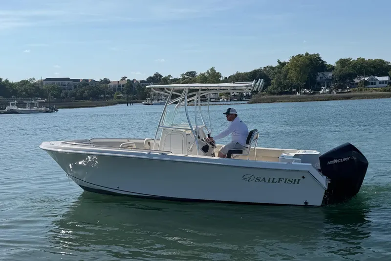 Slide: The Image of 2023 Sailfish 220 CC boat on calm water. - 7