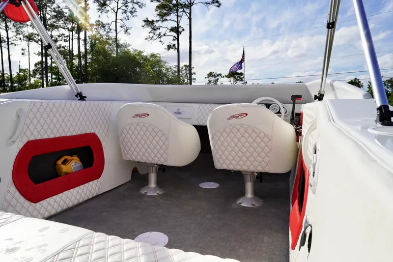 Slide: The Image of Interior of a 1996 Baja 20 Outlaw boat with white quilted seats and red accents. - 12