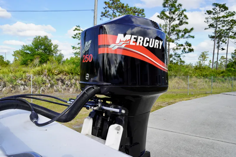Slide: The Image of 1996 Baja 20 Outlaw boat with Mercury 250 outboard motor, parked outdoors. - 15