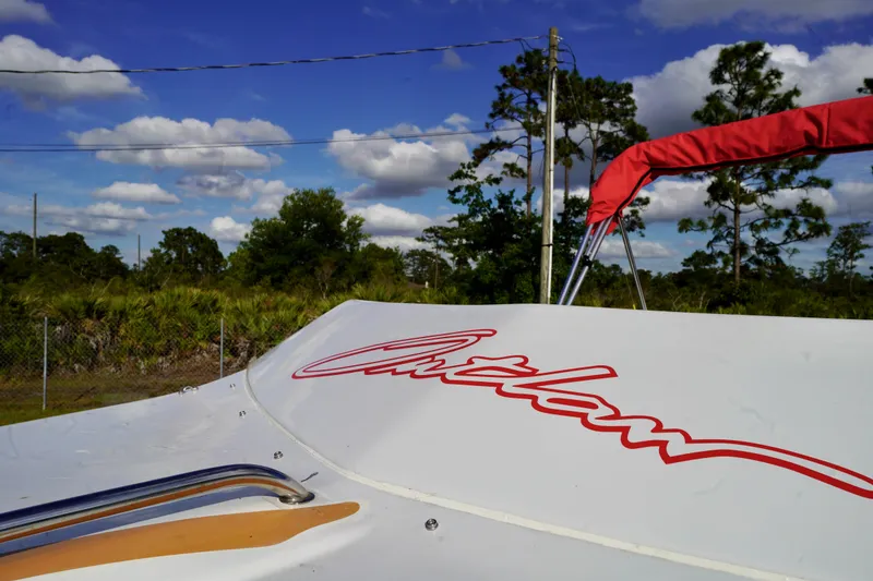 Slide: The Image of 1996 Baja 20 Outlaw boat with red lettering, set against a scenic outdoor backdrop. - 5