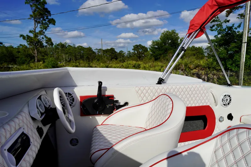 Slide: The Image of Interior of a 1996 Baja 20 Outlaw boat with white and red seating. - 7