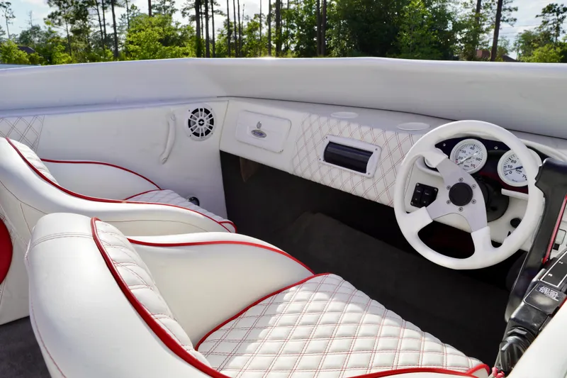 Slide: The Image of Interior of a 1996 Baja 20 Outlaw boat with white and red seating. - 8