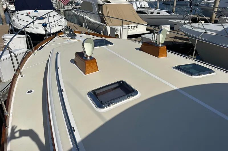 Slide: The Image of 2003 Grand Banks 43 Eastbay HX yacht deck with hatches and lights at marina. - 10