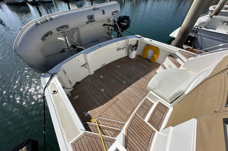Slide: The Image of 2003 Grand Banks 43 Eastbay HX yacht deck with wooden flooring and seating area. - 11
