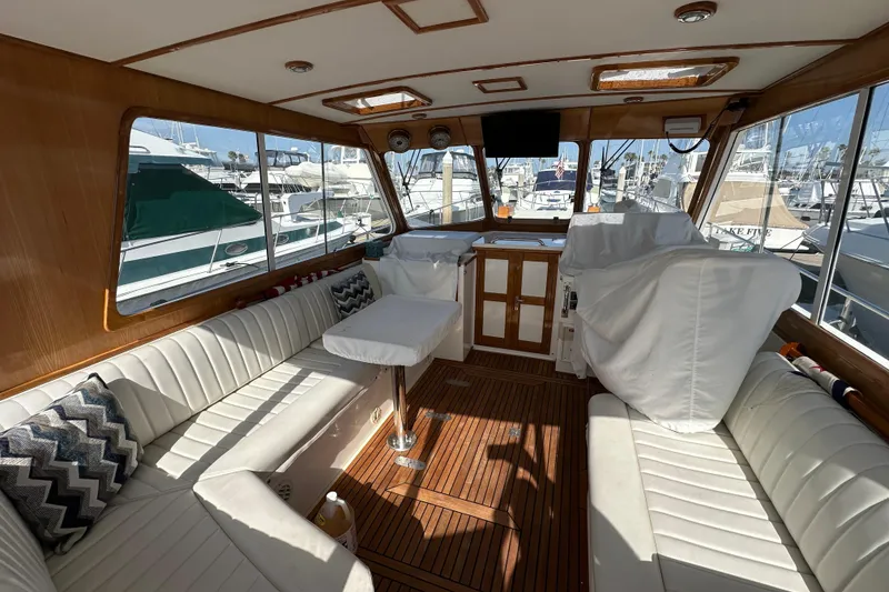 Slide: The Image of Luxurious 2003 Grand Banks 43 Eastbay HX yacht interior with white seating and wooden accents. - 15