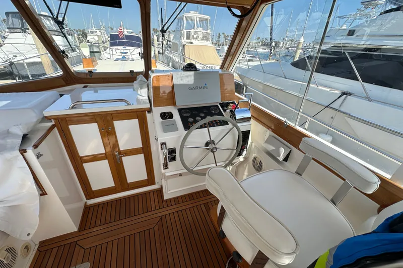 Slide: The Image of Helm of 2003 Grand Banks 43 Eastbay HX with wooden accents and Garmin navigation. - 16