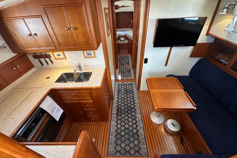 Slide: The Image of Interior of 2003 Grand Banks 43 Eastbay HX yacht with kitchen, seating, and TV. - 18