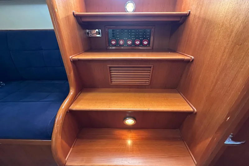 Slide: The Image of Interior stairs of 2003 Grand Banks 43 Eastbay HX with wooden finish and control panel. - 19