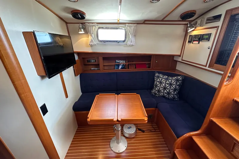 Slide: The Image of Interior of 2003 Grand Banks 43 Eastbay HX with cozy seating and wooden table. - 20
