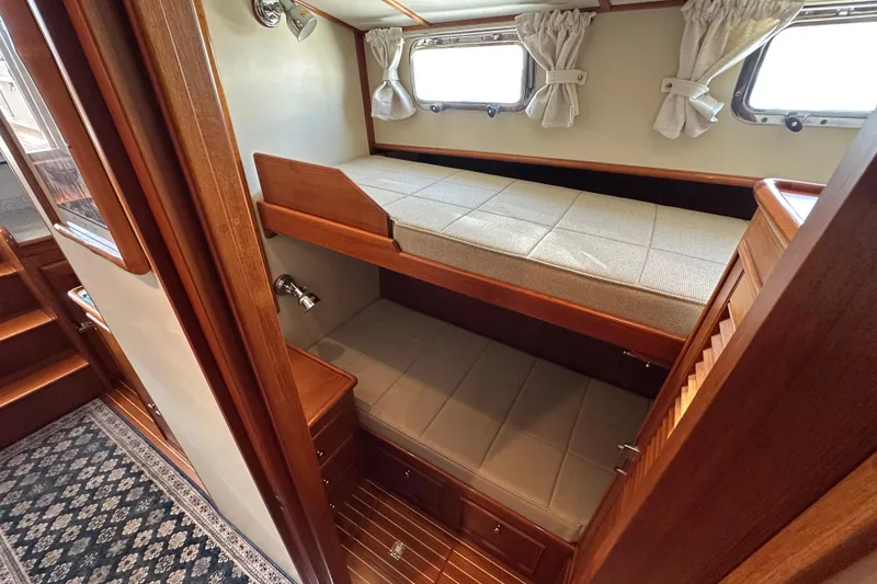 Slide: The Image of Interior of 2003 Grand Banks 43 Eastbay HX with cozy bunk beds and wooden finish. - 21