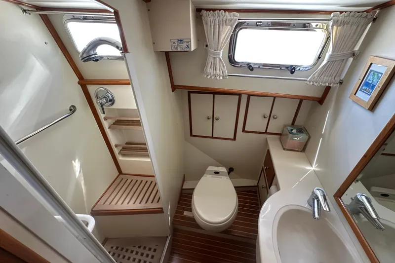 Slide: The Image of Luxurious 2003 Grand Banks 43 Eastbay HX yacht bathroom with modern fixtures and wooden accents. - 25