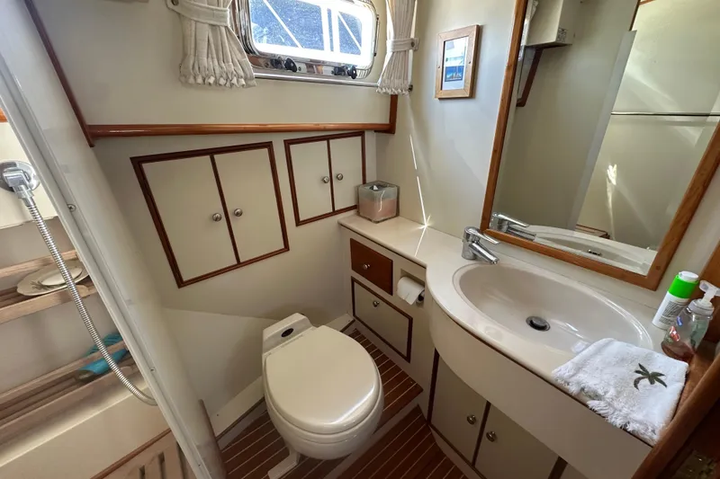 Slide: The Image of Bathroom interior of 2003 Grand Banks 43 Eastbay HX yacht, featuring sink and storage cabinets. - 26