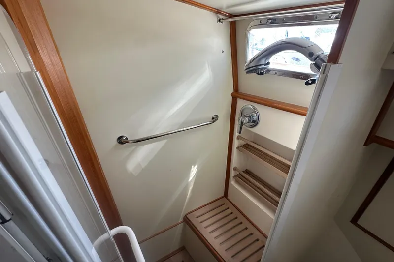 Slide: The Image of Shower area in 2003 Grand Banks 43 Eastbay HX yacht with wooden accents and window. - 27