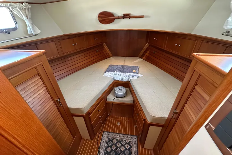 Slide: The Image of Luxurious 2003 Grand Banks 43 Eastbay HX cabin with elegant wood finish and cozy bedding. - 28