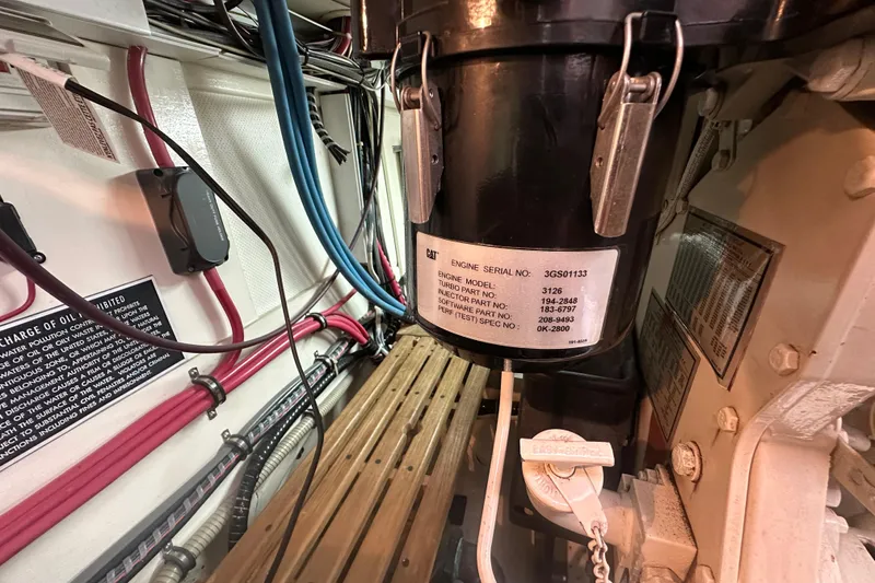 Slide: The Image of Engine room of 2003 Grand Banks 43 Eastbay HX with visible wiring and engine serial details. - 31