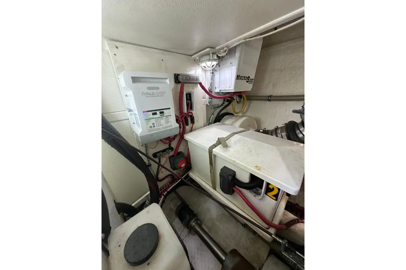 Slide: The Image of Engine room of 2003 Grand Banks 43 Eastbay HX with electrical components and wiring. - 32