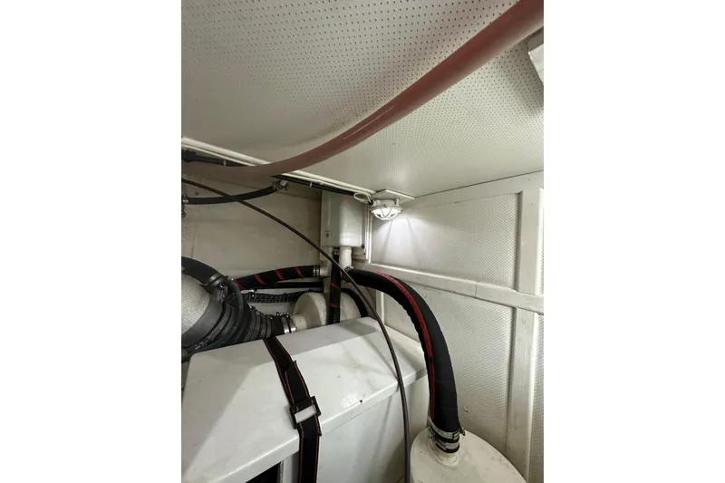 Slide: The Image of Engine room of 2003 Grand Banks 43 Eastbay HX with visible pipes and machinery. - 34