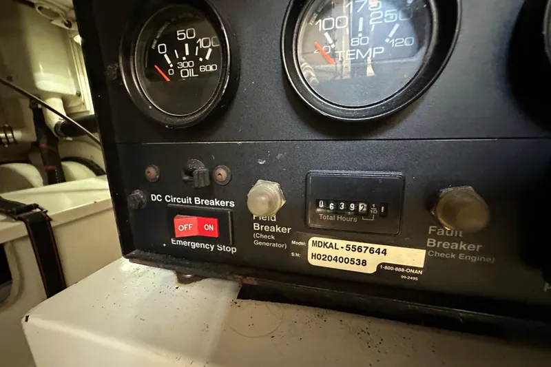 Slide: The Image of Control panel of a 2003 Grand Banks 43 Eastbay HX with gauges and circuit breakers. - 36