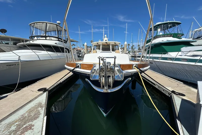 Slide: The Image of 2003 Grand Banks 43 Eastbay HX yacht docked between boats in marina. - 5