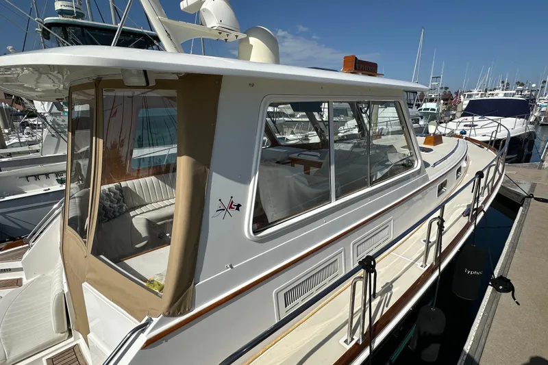 Slide: The Image of 2003 Grand Banks 43 Eastbay HX yacht docked at marina under clear blue sky. - 8