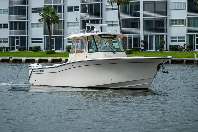 The Image of 2020 Grady-White Canyon 336 boat cruising near waterfront buildings. - 0