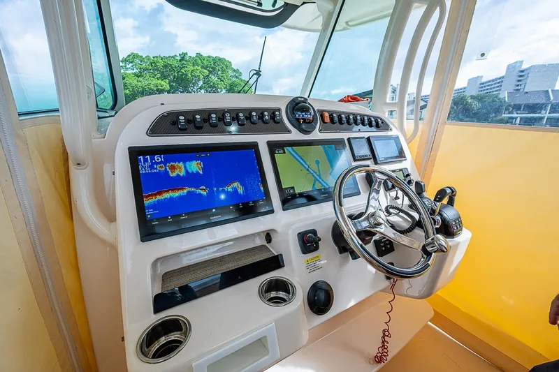 Slide: The Image of Control panel of 2020 Grady-White Canyon 336 boat with navigation screens and steering wheel. - 15
