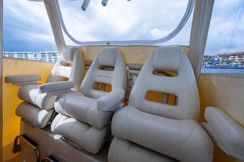 Slide: The Image of Luxury seating on 2020 Grady-White Canyon 336 boat, featuring plush white leather chairs. - 16