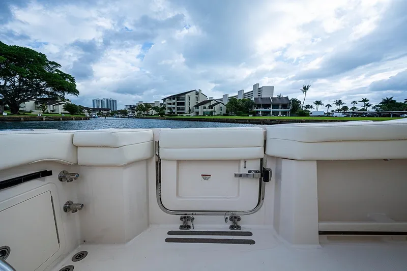 Slide: The Image of 2020 Grady-White Canyon 336 boat interior with waterfront view and cloudy sky. - 26