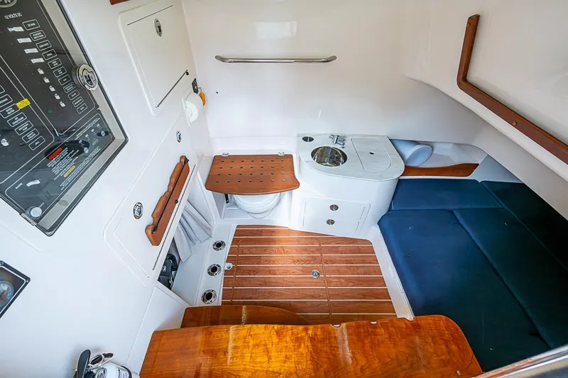 Slide: The Image of 2020 Grady-White Canyon 336 cabin interior with seating, sink, and control panel. - 29