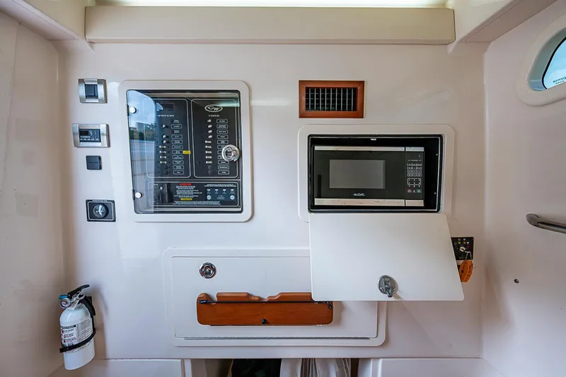Slide: The Image of Control panel and microwave inside 2020 Grady-White Canyon 336 boat cabin. - 31